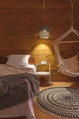 a bedroom with a hammock and a bed and a chair at The Monkee Studios in Sveti Vlas
