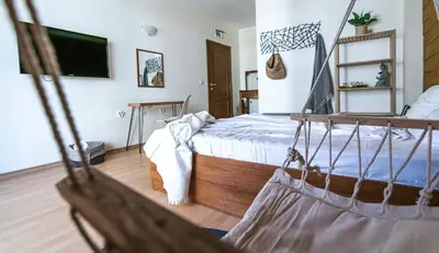 a bedroom with a bed with a net at The Monkee Studios in Sveti Vlas
