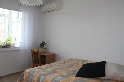 a bedroom with a bed and a table and a window at Sunny Cozy Flat in the Centre, close to beach, 4 rooms, 105sqm in Varna City