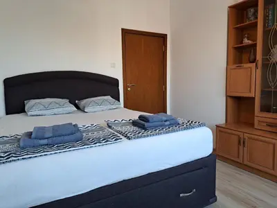 a bedroom with a bed with two blue towels on it at Sunny Cozy Flat in the Centre, close to beach, 4 rooms, 105sqm in Varna City
