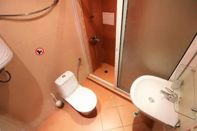 a bathroom with a shower and a toilet and a sink at Menada Apolon Apartments in Sozopol