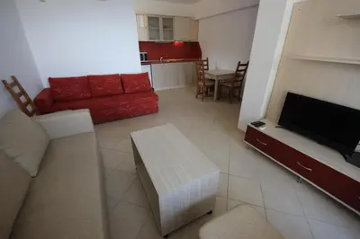 a living room with a couch and a flat screen tv at Menada Apolon Apartments in Sozopol