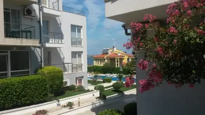 a view from the balcony of a building with pink flowers at Menada Apolon Apartments in Sozopol