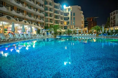 a large swimming pool at a hotel at night at Grenada - Menada Apartments in Sunny Beach