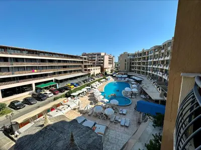 an aerial view of a resort with a pool and chairs at Grenada - Menada Apartments in Sunny Beach
