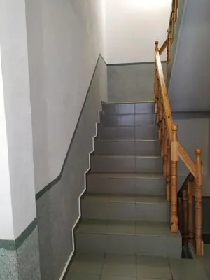 a set of stairs in a building with a stair case at Фамилна къща Джоко in Kiten