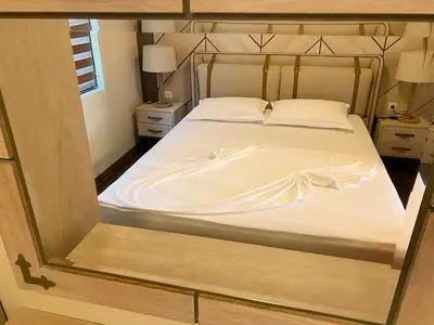 a bedroom with a large bed with white sheets at Gradina Forest Villas in Sozopol