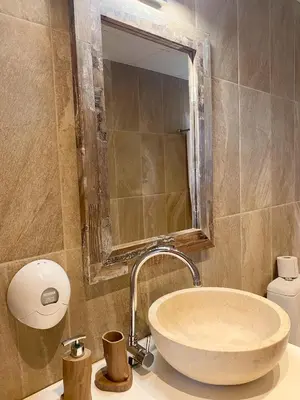 a bathroom with a sink with a mirror and a tub at Gradina Forest Villas in Sozopol