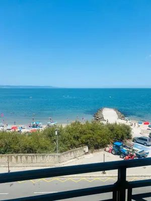 a view of a beach with people in the water at Golden Sea View New in Pomorie