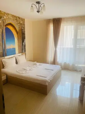 a bedroom with a large bed with a large window at Golden Sea View New in Pomorie