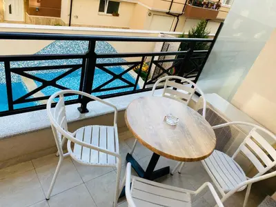 a table and two chairs on a balcony at Golden Sea View New in Pomorie