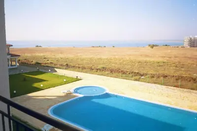 a swimming pool on a balcony with a view of the ocean at Apartment Rutland Beach in Ravda