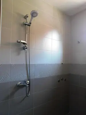 a shower with a shower head in a bathroom at HomeLine Kazakovi in Nesebar