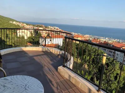 a balcony with a table and a view of the ocean at Vila Vista Вила Виста in Sveti Vlas