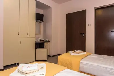 a small room with two beds and a kitchen at Vila Vista Вила Виста in Sveti Vlas