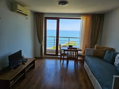 a living room with a couch and a view of the ocean at INESA in Tsarevo