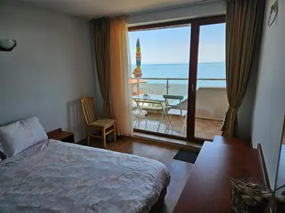 a bedroom with a bed and a view of the ocean at INESA in Tsarevo