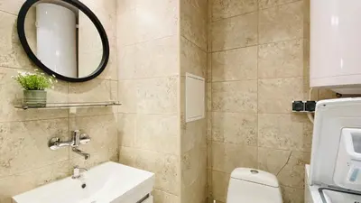 a bathroom with a sink and a mirror and a toilet at APARTELLO Modern Apartments in DownPARK in Sunny Beach