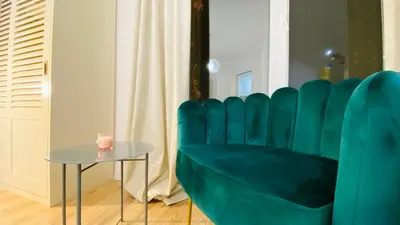 a room with a table and a green chair at APARTELLO Modern Apartments in DownPARK in Sunny Beach