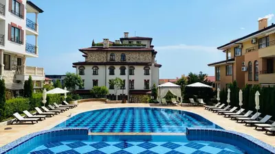 a swimming pool in front of a building at APARTELLO ARTUR - Modern Studios - Sveti Vlas in Sveti Vlas