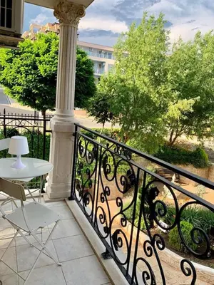 a balcony with a table and chairs on a railing at APARTELLO ARTUR - Modern Studios - Sveti Vlas in Sveti Vlas