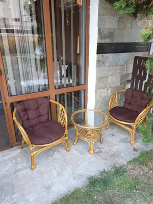 two wicker chairs and a table on a porch at MitProt luks studio Panorama Bay 2 ap39 in Sveti Vlas