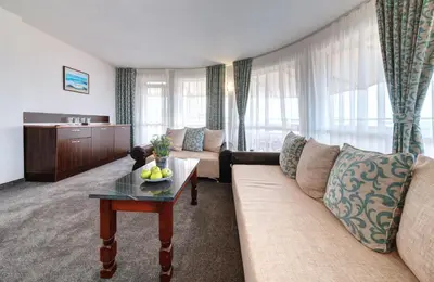 a living room with a couch and a table at хотел Свети Николай Приморско in Primorsko