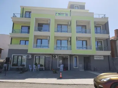 a yellow and green building with a lot of windows at Хотел Paradise in Tsarevo