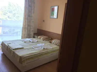 a bedroom with a bed with towels on it at Апартамент с две спални в комплекс Лъки 2 Свети Влас in Sveti Vlas
