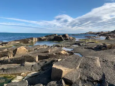 a group of rocks on the ocean with the water at Breeze Guest House in Chernomorets