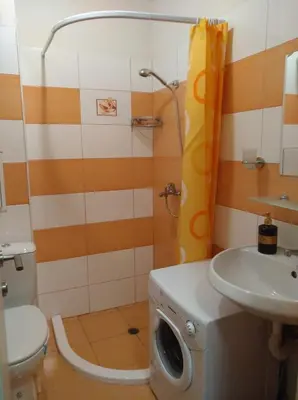 a bathroom with a toilet and a sink and a shower at PARUS-2-STUDIO in Pomorie