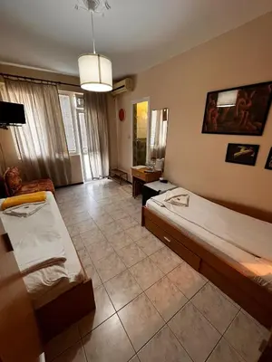 a room with two beds and a couch at Kъща за гости Христина in Lozenets
