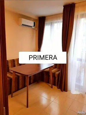 a wooden table in a room with a window at APARTAMENT PRIMERA in Varna City