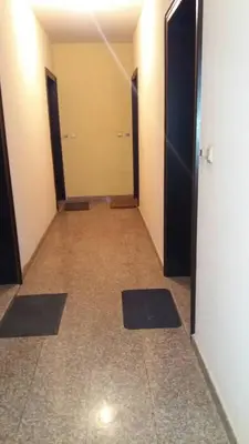 an empty hallway with two doors and mats on the floor at APARTAMENT PRIMERA in Varna City