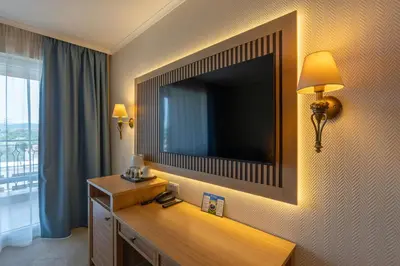 a hotel room with a large television on the wall at DIT Majestic Beach Resort in Sunny Beach