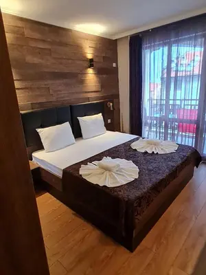 a bedroom with a bed with two pillows on it at Mit Prot luks Apartment Panorama Bay 2 ap109 in Sveti Vlas