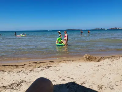 a group of people in the water at the beach at Hacienda Beach Apartment mit Meerblick in Sozopol