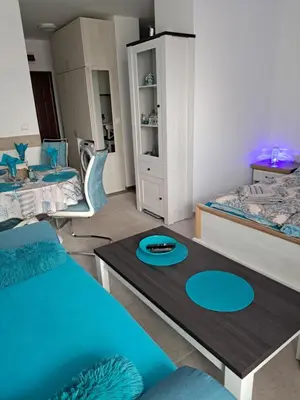 a living room with two beds and a table at Stensi Atlantis studia in Ravda