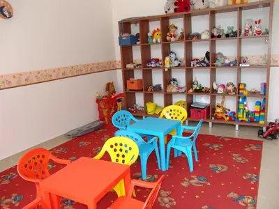 a room with a table and chairs and shelves at Apart Hotel Efir in Sunny Beach