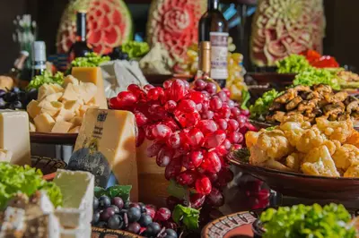 a buffet of food with cheese and grapes and other foods at Hotel & SPA Diamant Residence - All Inclusive in Sunny Beach