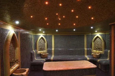 a room with three toilets and a table and chairs at Hotel & SPA Diamant Residence - All Inclusive in Sunny Beach