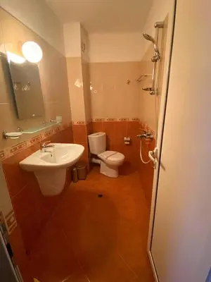 a bathroom with a toilet and a sink at Guest House Kostovi in Kiten