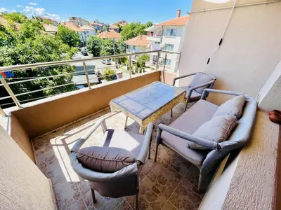 a balcony with two chairs and a table and chairs at Kastela Guest House in Chernomorets