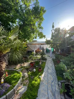 a garden with plants and a walkway at Kastela Guest House in Chernomorets