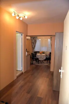 a living room with wooden floors and a dining room at City apartments in Varna City