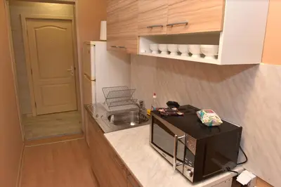 a small kitchen with a microwave on a counter at City apartments in Varna City