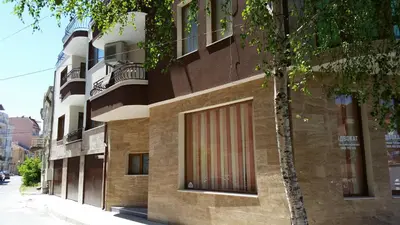 a building with a red door on the side of it at Guest rooms Sveti Nikola in Pomorie