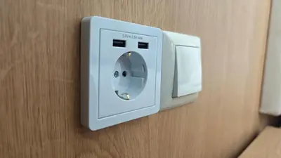 a white lightswitch on a wall in a room at Family Hotel Milev in Sveti Vlas