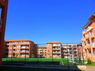 a tennis court in front of some apartment buildings at Sunny Day 6 - Menada Apartments in Sunny Beach