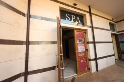 a building with a sign above the entrance to a spa at Menada Apartments in Karolina in Sunny Beach